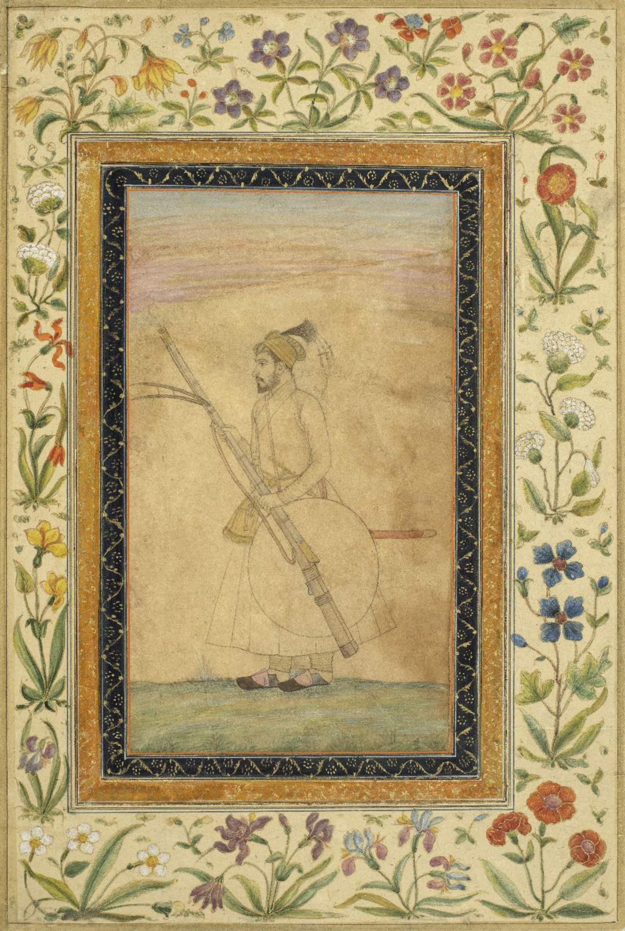 A Mughal prince standing in a landscape, holding a musket, sword and shield, formerly from an al...