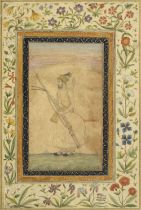 A Mughal prince standing in a landscape, holding a musket, sword and shield, formerly from an al...