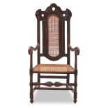 ENGLISH CARVED OAK AND CANED ARMCHAIR