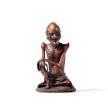 A CARVED BOXWOOD FIGURE OF AN ASCETIC 19th/20th century