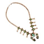 A SILVER AND TURQUOISE SQUASH BLOSSOM NECKLACE