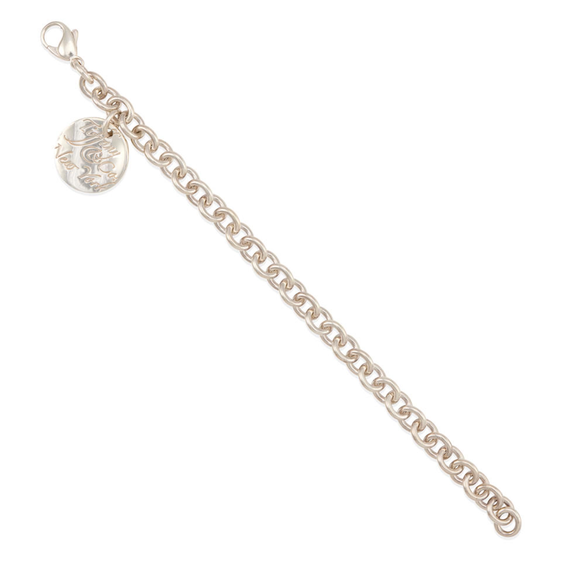 TIFFANY & CO.: A STERLING SILVER BRACELET WITH CHARM