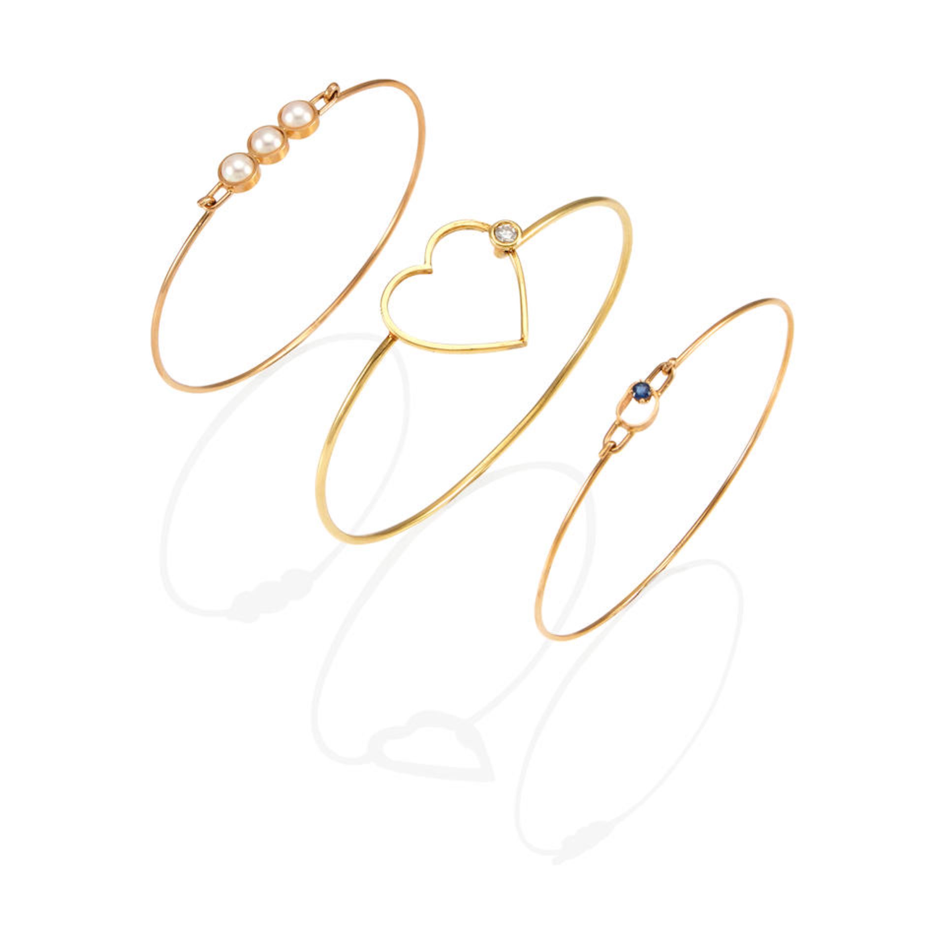 THREE GOLD AND GEM-SET BANGLE BRACELETS