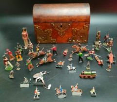 A Victorian tea caddy box contains antique lead soldiers