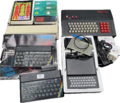 A selection of vintage consoles; A boxed zx81, two zx spectrums, a tandata tp192