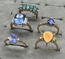 Four 10ct and one 9ct yellow gold rings set with various gem stones. Ethiopian opal, Purple