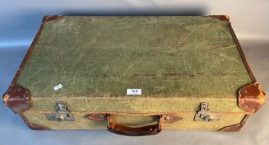 An antique canvas and leather bound suit case