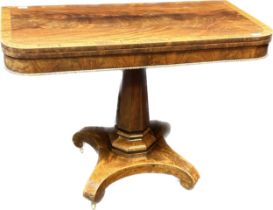 Regency Rosewood tea table, the swivel top extending above an octagonal column ending in a quadiform