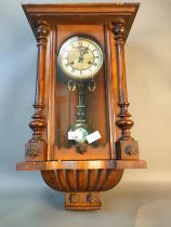 A Victorian Vienna wall clock with key and pendulum [62.5Cm]