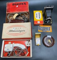 A selection of collectable odds; a boxed brownie bellows camera & measuring tape