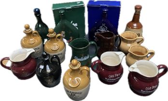 A collection of whisky & courvoisier decanters & jugs; Old parr whisky pub jugs & crabbie whisky