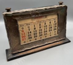 Birmingham silver framed desk calendar. Month cards present. [12x21x4.5cm]