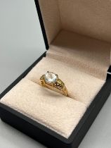 9ct yellow gold ring set with an oval cut pale blue stone. [Ring size N] [3.14Grams]