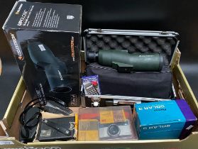 A box of various cameras & a Celestron spotting scope