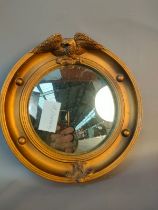 A Regency small convex framed mirror with bird motif. [19cm]