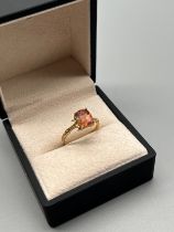 10ct yellow gold ring set with a cushion cut pink stone. [Ring size P] [2.36Grams]