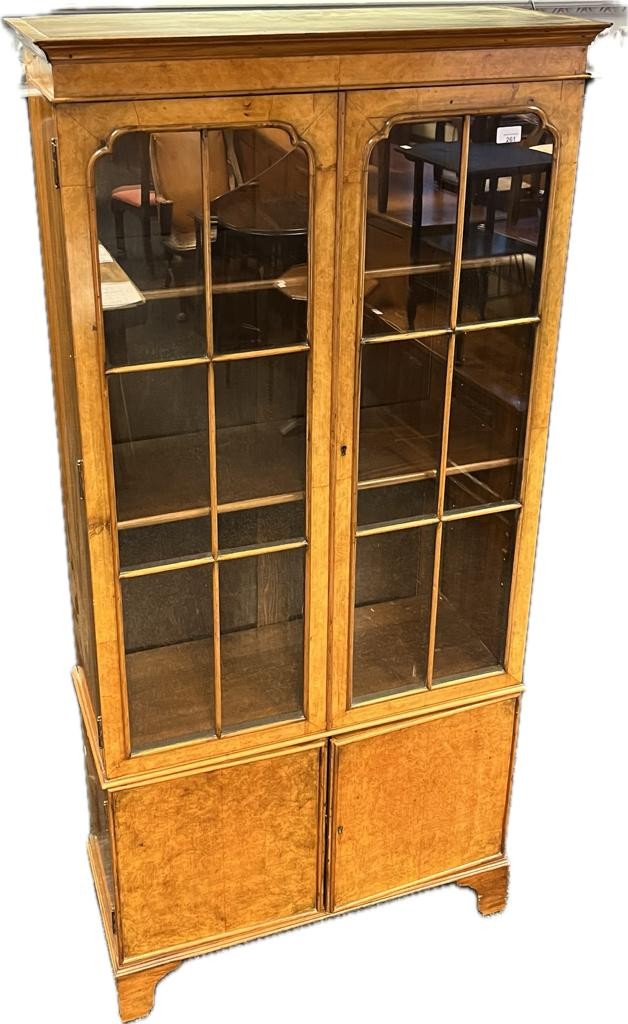 19th century book case by Maple & Co, the moulded cornice above two glazed cupboard doors opening to