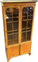 19th century book case by Maple & Co, the moulded cornice above two glazed cupboard doors opening to