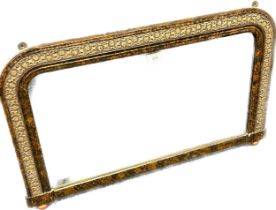 Antique over mantle mirror within a walnut and gilded frame