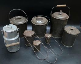 A collection of eight antique tin milk cans