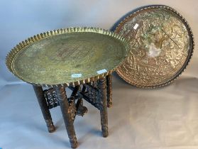 A large Arabic brass topped table together with a large eastern copper god designed wall charger [