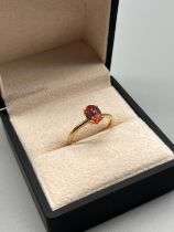 10ct yellow gold ring set with an oval cut fire opal. [Ring size P] [2.20Grams]