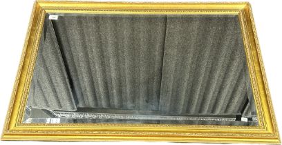 Reproduction over mantel bevel edge mirror, ornate moulded gilt frame. [104x74cm]