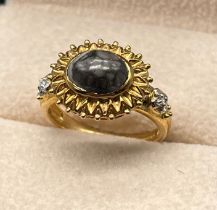 9ct yellow gold ring set with a cabochon gem stone flanked by diamond stone shoulders [3.60grams] [