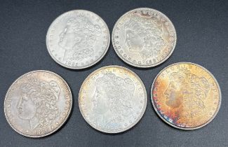 A lot of five Silver Morgan One Dollar Coins. 1880, 1885, 1886 & two 1887.