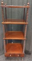 19th century mahogany four tier what not. Raised on bobble supports. [119x44x35cm]