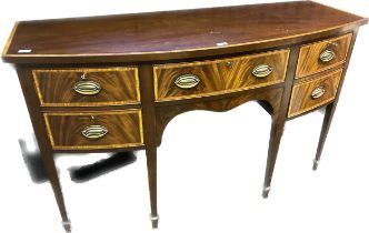 Reproduction of a 19th century bow front sideboard. Mahogany with satin wood trims. Raised on square