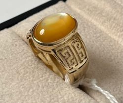 9ct yellow gold ring set with a yellow opalescent cabochon gem stone ring. [Ring size Q] [6.20Grams]