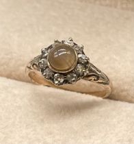 Antique 9ct yellow gold ring set with a round cabochon agate stone surrounded by round cut diamonds.