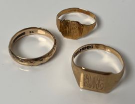 Three 9ct yellow gold rings; Wedding band and two signet rings. [6.69grams]