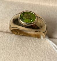 9ct yellow gold ring set with an oval cut green tourmaline gem stone. [Ring size Q] [5.18Grams]