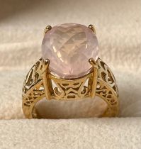 9ct yellow gold ring set with an oval cut pink gem stone. [Ring size N] [7.32Grams]