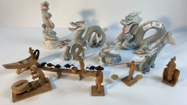 A collection of John Jenkins porcelain dragon figures along with a selection of eastern wooden