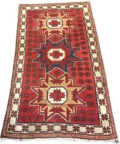 Kazak red ground rug. [178x102cm]