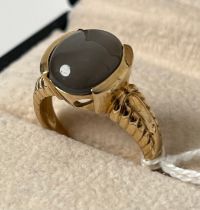 9ct yellow gold ring set with an oval cut grey opalescent cabochon stone [Ring size N] [4.79Grams]