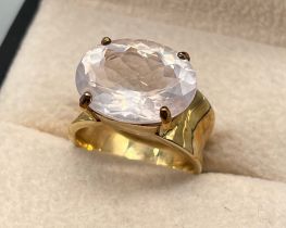 9ct yellow gold ring set with an oval cut pinkish white gem stone. [Ring size M] [6.96Grams]