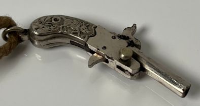 Early 20th century miniature firing pistol. E.P raised relief handle depicting Boar, stag and