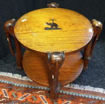 20th century teak African table of round form; Supported and raised on carved elephant legs and