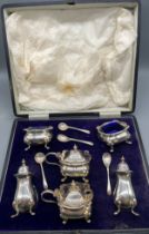 Boxed six piece Birmingham silver condiment set produced by Walker & Hall. All have blue liners