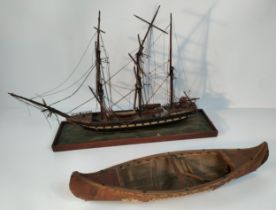 A model of a British boat on stand along with a Native American boat model [77.5cm]