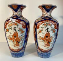 A pair of 20th century Japanese Imari pattern vases, decorated with four pictorial panels