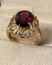 9ct yellow gold ring set with an oval cut red garnet. [Ring size N] [4.96Grams]