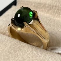 9ct yellow gold ring set with a green speckled cabochon gem stone. [Ring size N] [6.18Grams]