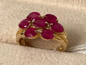 9ct yellow gold ring set with seven oval cut ruby stones. [Ring size N] [3.50Grams]