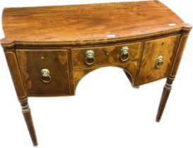 Early 19th century Mahogany desk/ sideboard. Bow front, three drawers fitted wit raised relief brass