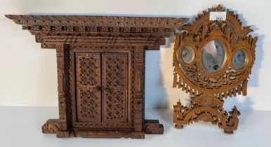 A carved wooden Hindu temple deity wall hanging frame along with an oriental carved wooden table